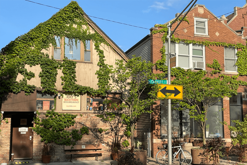 A charming bed and breakfast covered in greenery, located at Leavitt Street.